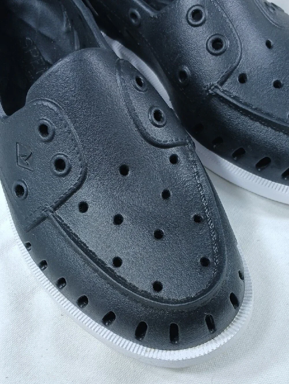 Sperry Black Perforated Slip-On Boat Shoes with White Sole